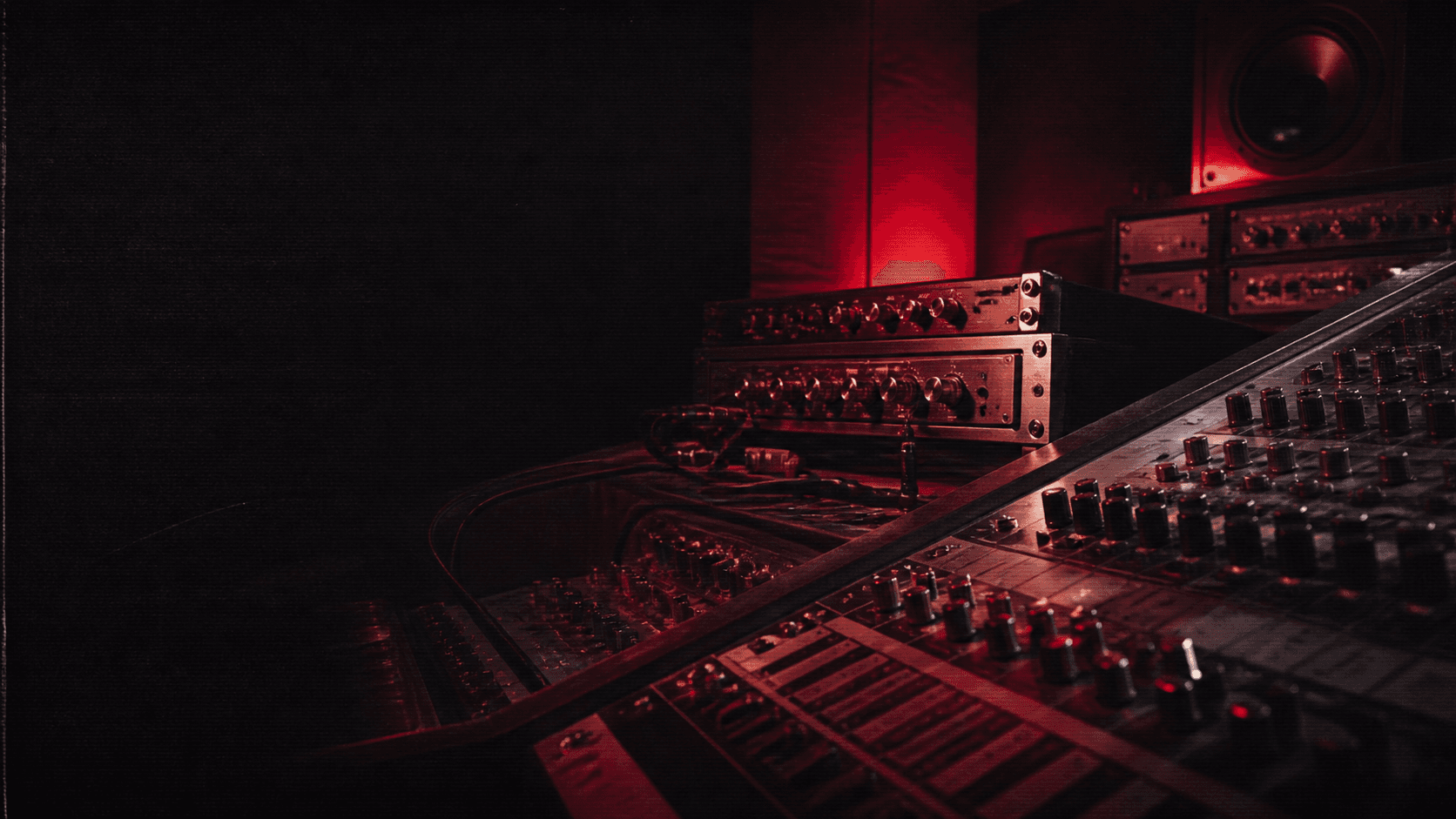An original red-lit recording studio with analog mixing hardware